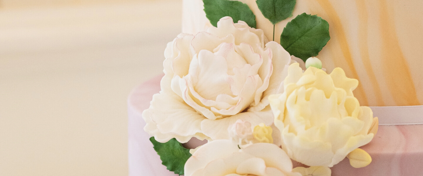 A pink wedding cake with flower decoration