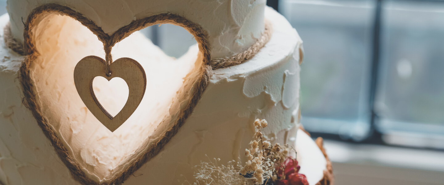 A wedding cake with a heart shape out of the center