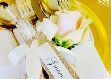 Cutlery wrapped in a bow with a name tag